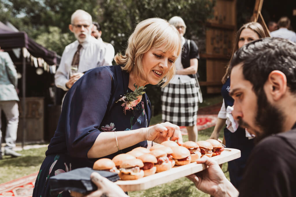 Burger sliders being served as appetisers at a wedding
